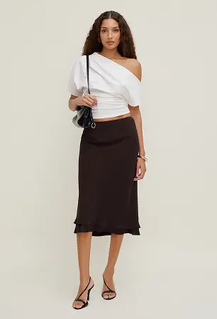 Model is wearing a white off shoulder T shirt and a burgundy midi skirt.