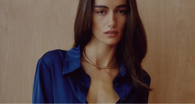 Model is wearing a blue satin shirt.